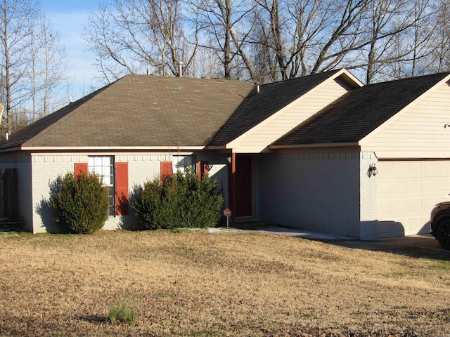 ranch-style home featuring a garage, a front lawn, and brick siding