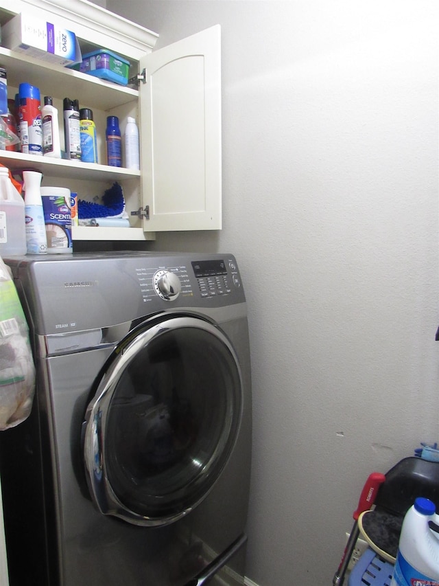 clothes washing area with cabinet space and washer / clothes dryer