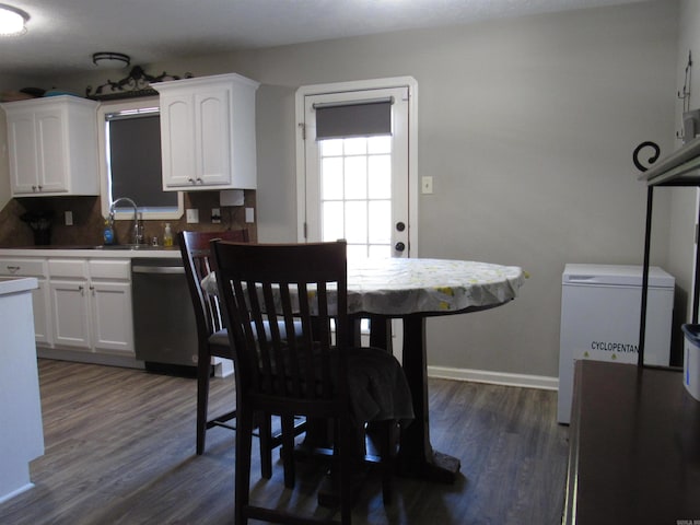 dining area with dark wood-type flooring and baseboards