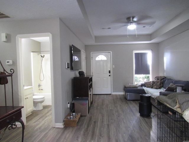 entrance foyer featuring dark wood-type flooring, visible vents, and baseboards