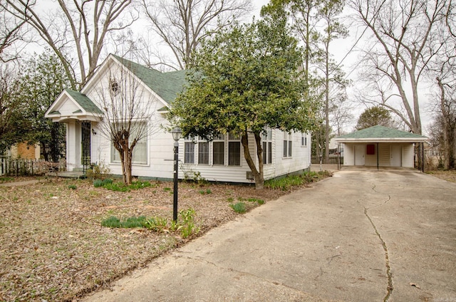 view of front of property featuring concrete driveway and roof with shingles