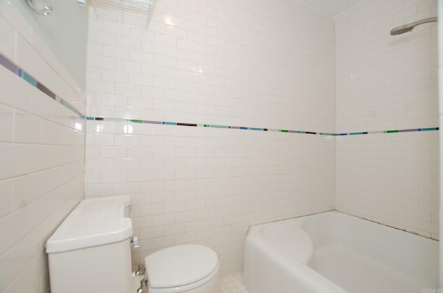 full bathroom featuring tile walls, toilet, and bathing tub / shower combination