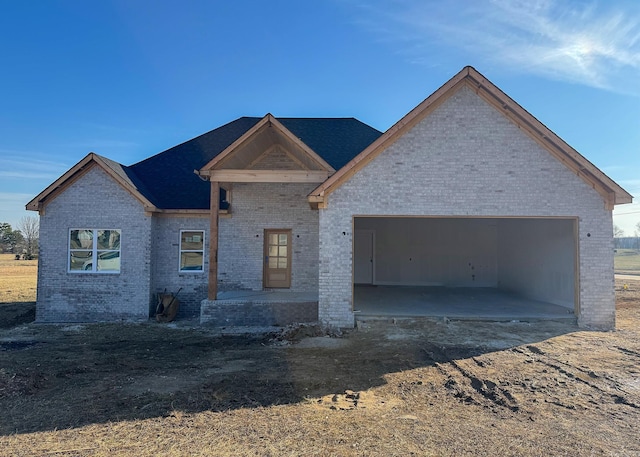 view of front of house featuring a garage and brick siding