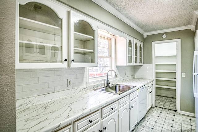 kitchen featuring white cabinets, glass insert cabinets, ornamental molding, white dishwasher, and a sink