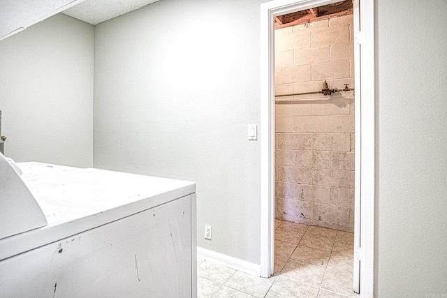 washroom with washer / dryer and light tile patterned floors