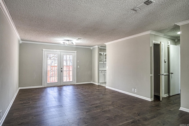 unfurnished room with french doors, dark wood finished floors, visible vents, ornamental molding, and baseboards