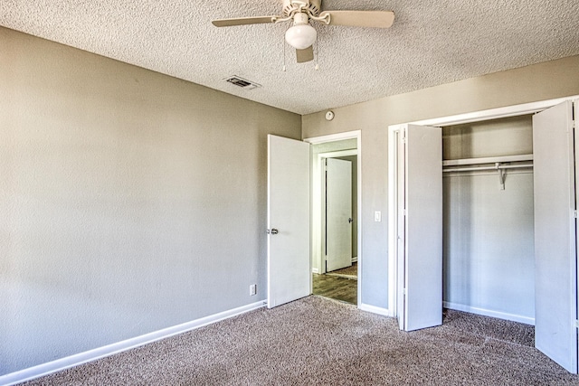 unfurnished bedroom with dark colored carpet, a closet, visible vents, ceiling fan, and baseboards