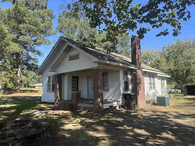 bungalow-style home featuring central AC and a chimney