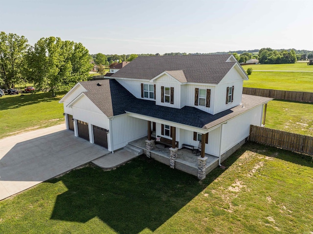 modern farmhouse featuring driveway, a front lawn, a shingled roof, and fence