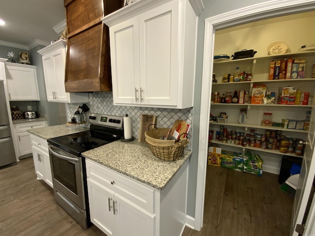 kitchen with stainless steel electric range oven, ornamental molding, white cabinetry, and light stone countertops