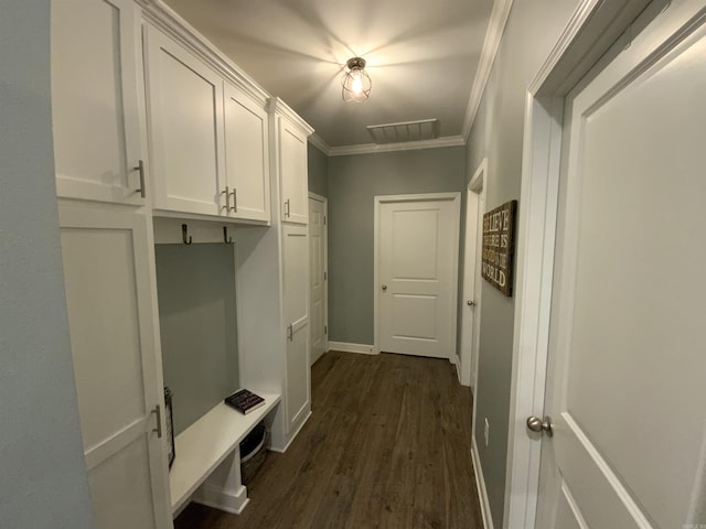 mudroom featuring baseboards, visible vents, ornamental molding, and dark wood-style flooring