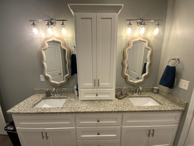 bathroom with a sink and double vanity