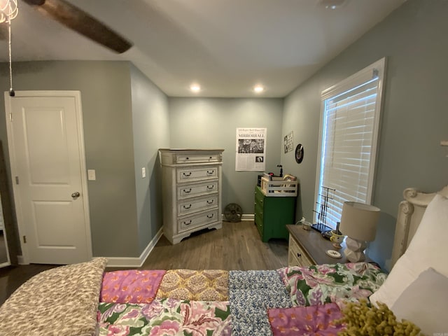 bedroom featuring baseboards, wood finished floors, and recessed lighting