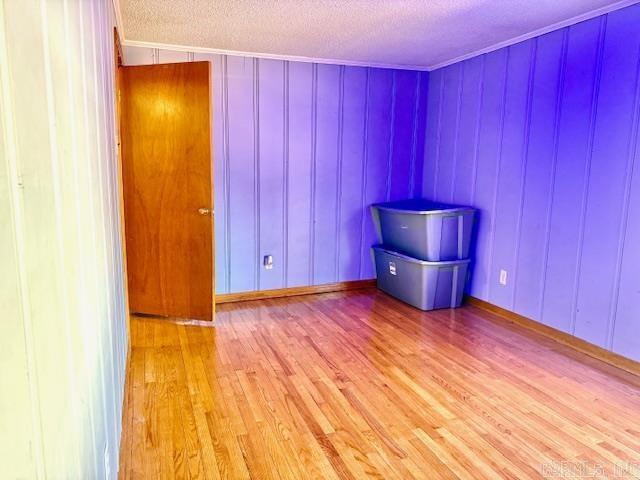840 S 16th St, Arkadelphia, AR 71923 - unfurnished room with crown molding, light wood-style flooring, and a textured ceiling