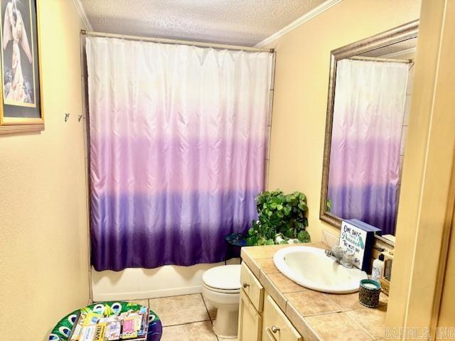 840 S 16th St, Arkadelphia, AR 71923 - full bathroom featuring toilet, ornamental molding, shower / bath combo, a textured ceiling, and tile patterned floors
