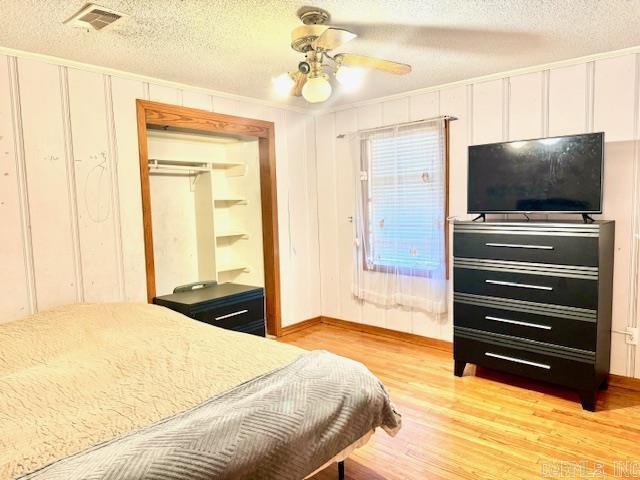 840 S 16th St, Arkadelphia, AR 71923 - bedroom featuring visible vents, a ceiling fan, a textured ceiling, light wood-type flooring, and a closet