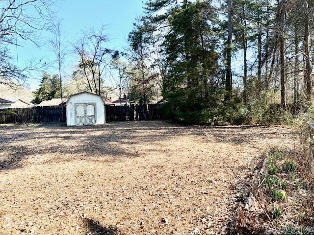 840 S 16th St, Arkadelphia, AR 71923 - view of yard with an outdoor structure, fence, and a shed