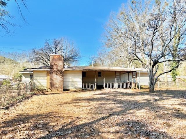 840 S 16th St, Arkadelphia, AR 71923 - rear view of house featuring covered porch, a chimney, and fence