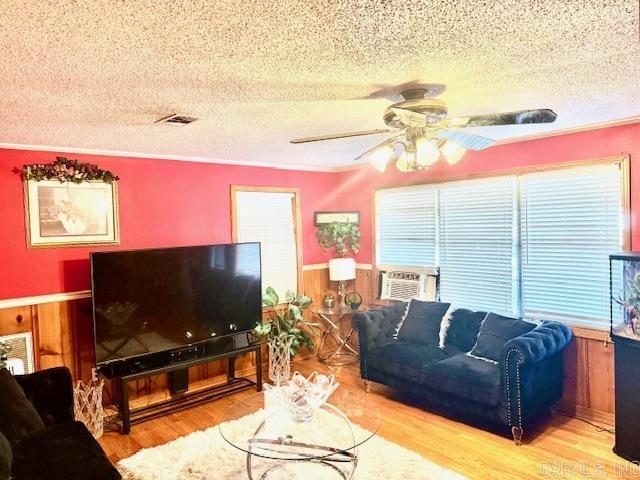 840 S 16th St, Arkadelphia, AR 71923 - living area with a healthy amount of sunlight, visible vents, wood finished floors, and wainscoting
