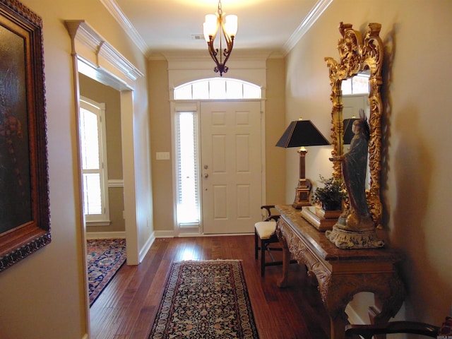 foyer with baseboards, visible vents, ornamental molding, and hardwood / wood-style floors