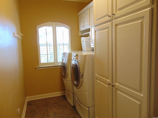 laundry area with independent washer and dryer, cabinet space, and baseboards