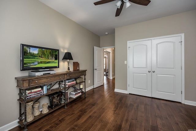 interior space featuring a closet, ceiling fan, baseboards, and wood finished floors