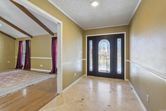 entrance foyer featuring a healthy amount of sunlight, vaulted ceiling with beams, baseboards, and a textured ceiling