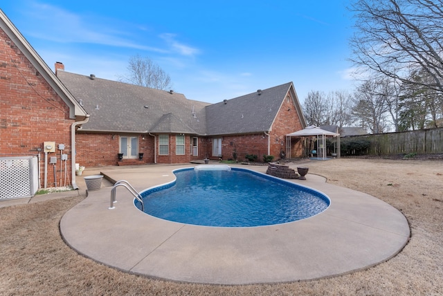 view of pool featuring a patio area, fence, a fenced in pool, and a gazebo