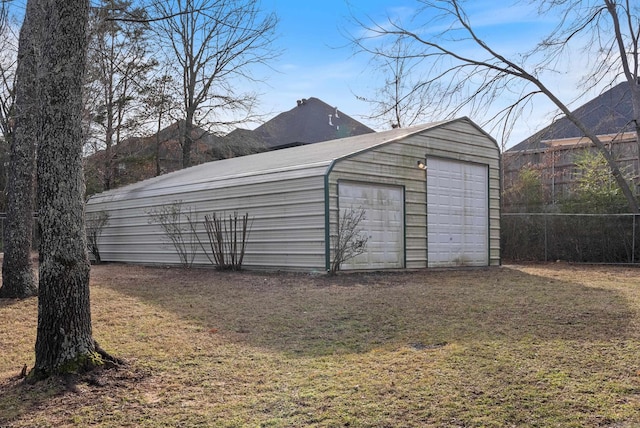 detached garage featuring fence