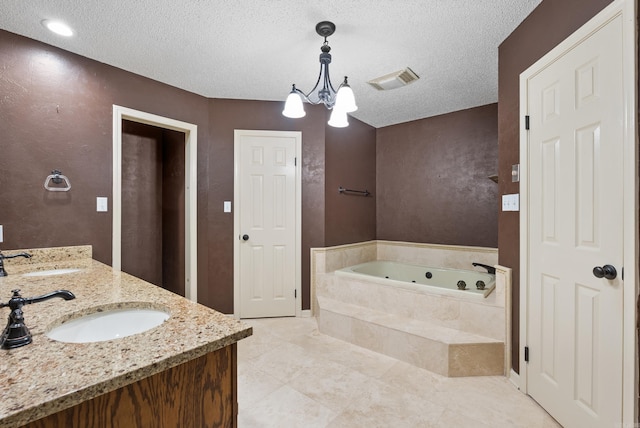 full bathroom featuring a whirlpool tub, double vanity, a sink, and visible vents