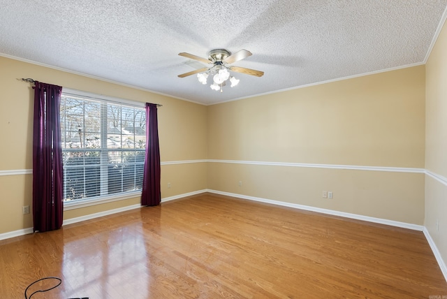 spare room with ceiling fan, wood finished floors, and baseboards