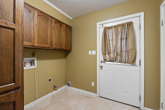 laundry room with a textured ceiling, hookup for a washing machine, hookup for an electric dryer, baseboards, and cabinet space