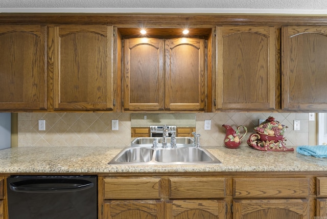 kitchen with a sink, decorative backsplash, brown cabinetry, and dishwasher