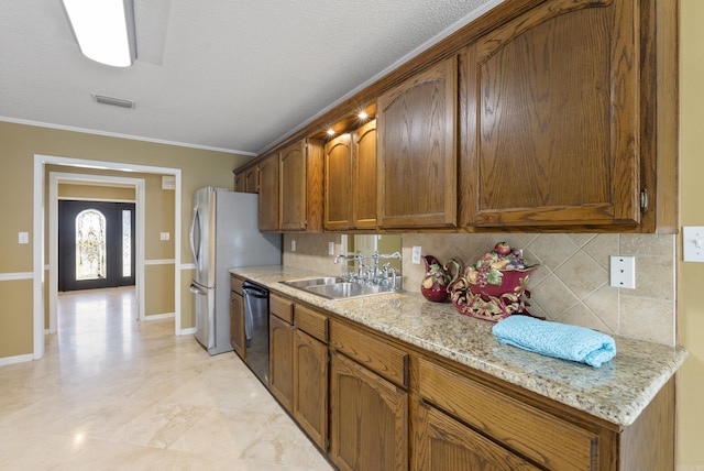 kitchen with brown cabinetry, a sink, light stone counters, and dishwasher