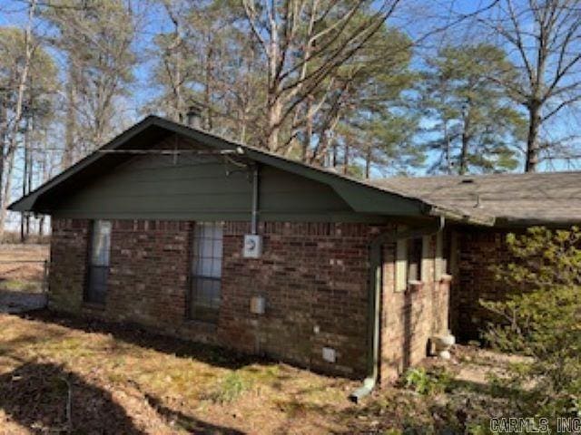 view of side of home featuring brick siding