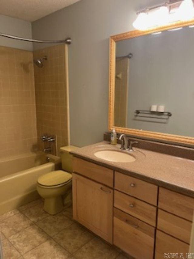 full bath featuring shower / washtub combination, tile patterned flooring, vanity, and toilet