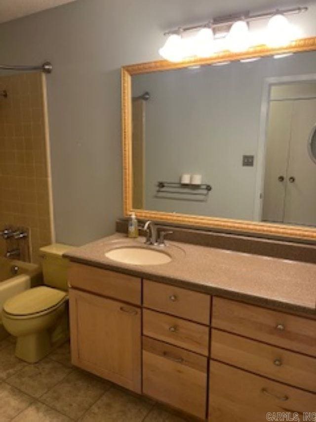 full bathroom featuring lofted ceiling, tile patterned flooring, toilet, bathtub / shower combination, and vanity