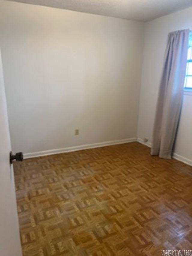 spare room featuring baseboards