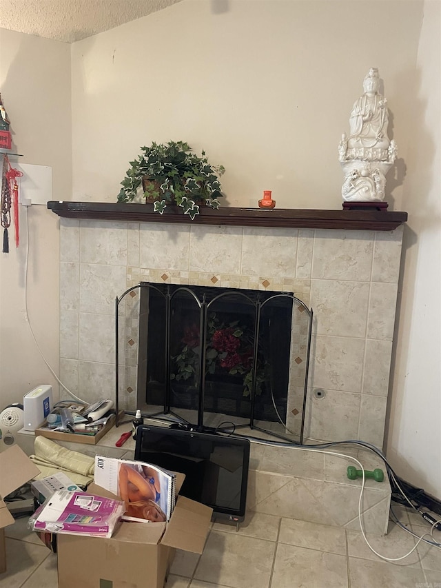 interior details featuring a textured ceiling and a fireplace