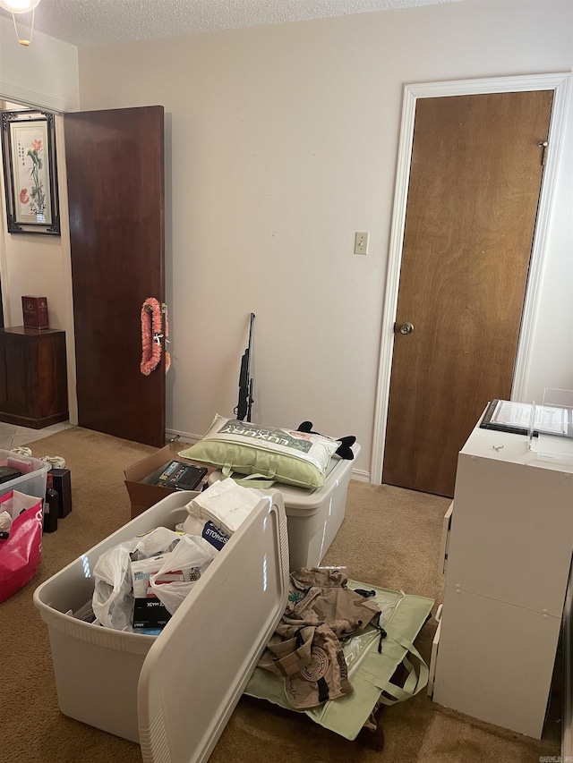 interior space with a textured ceiling, laundry area, carpet flooring, and washing machine and dryer