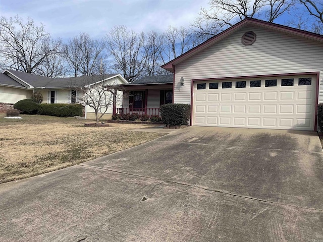 ranch-style house featuring covered porch, an attached garage, and concrete driveway