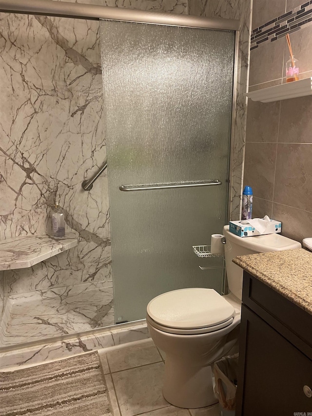 bathroom featuring a stall shower, vanity, and toilet