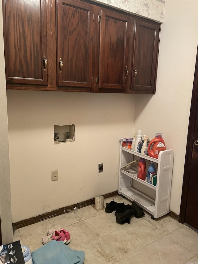 clothes washing area featuring baseboards, washer hookup, cabinet space, and hookup for an electric dryer