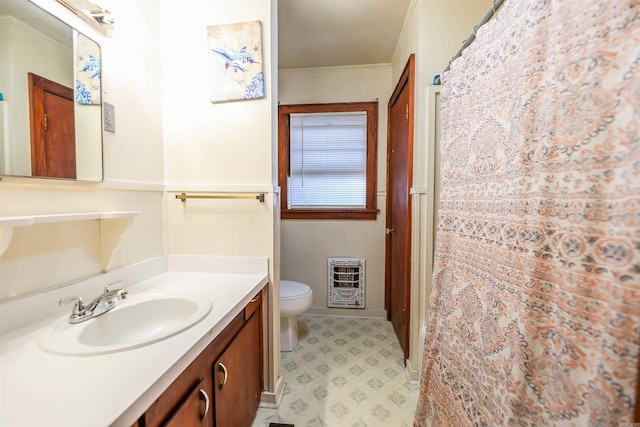 420 Sales St, Camden, AR 71701 - full bathroom with heating unit, toilet, ornamental molding, vanity, and tile patterned floors