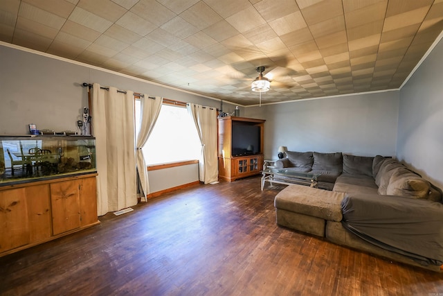 living area with baseboards, visible vents, ornamental molding, and dark wood-style flooring