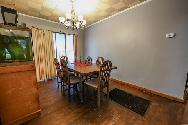 420 Sales St, Camden, AR 71701 - dining area with crown molding, visible vents, baseboards, dark wood finished floors, and an inviting chandelier