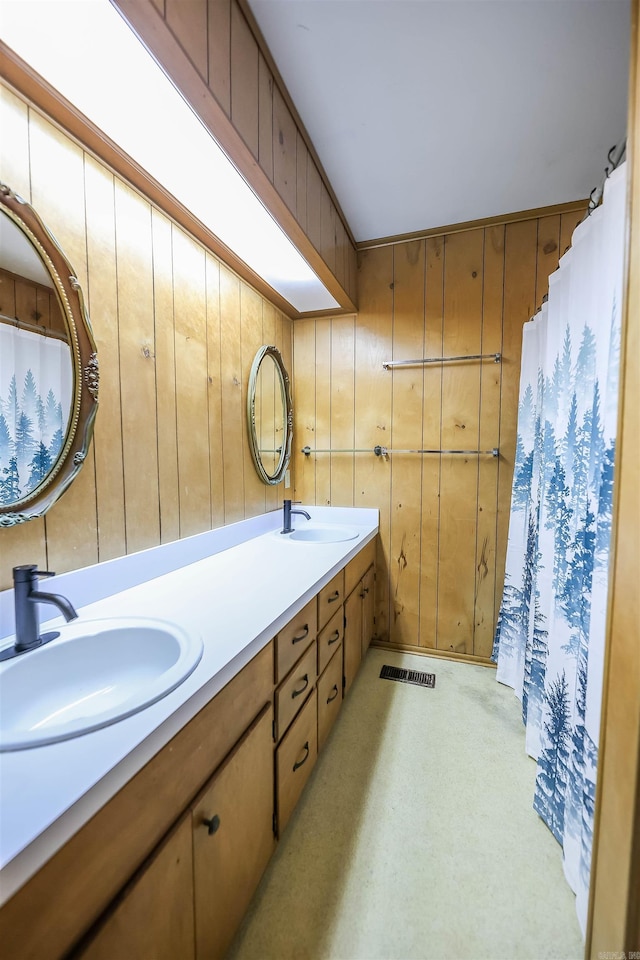 420 Sales St, Camden, AR 71701 - bathroom featuring double vanity, a sink, visible vents, and wooden walls