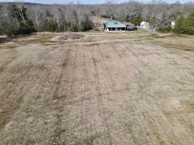 drone / aerial view featuring a wooded view