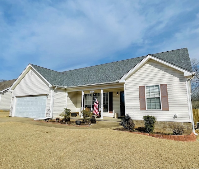 ranch-style house featuring a garage, covered porch, roof with shingles, and a front yard