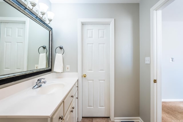 bathroom with baseboards and vanity